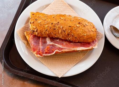 Appetizing ham sandwich served for breakfast on platter photo