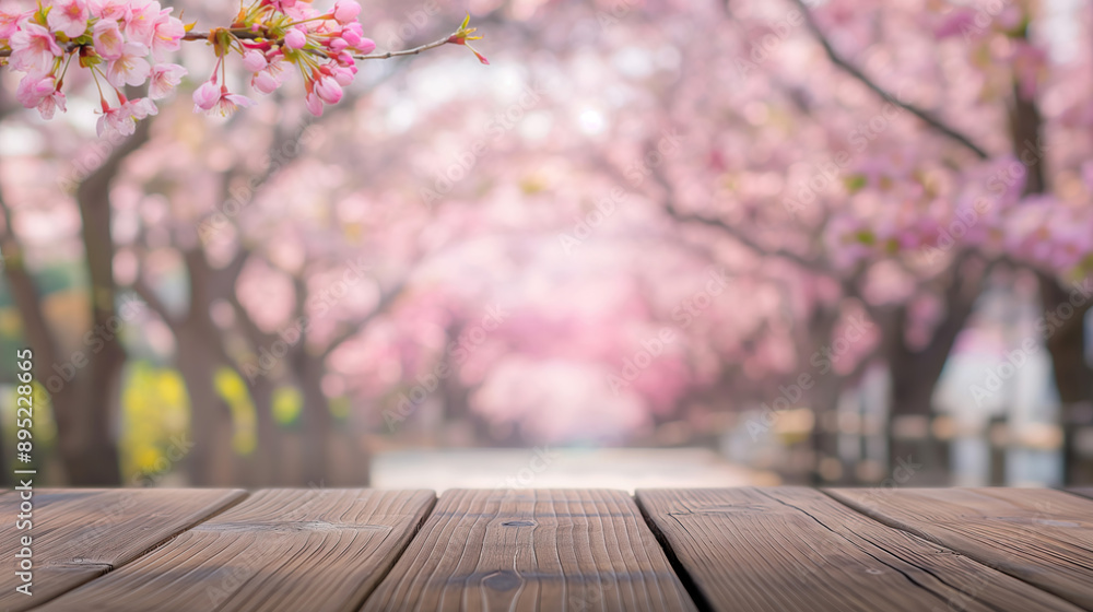 close up of empty wooden table with blurred japan sakura flower trees background