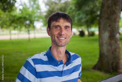 joyful cheerful middle-aged man in nature on a warm sunny day