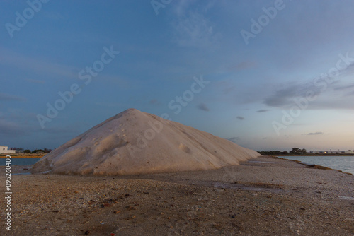 Blue hour during evening twilight after sunset at nature reserve Saline di Trapani with salt heap besides salt fields, Contrada Nubia, Sicily, Italy photo