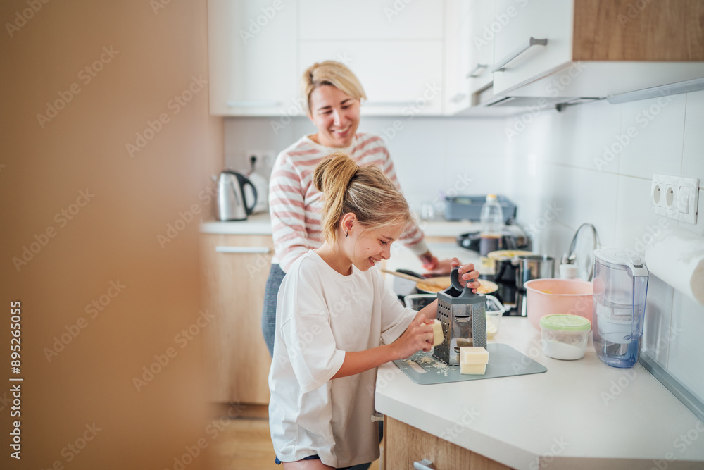 Mother and daughter enjoy cooking session together in modern kitchen sharing togetherness time and bonding over meal preparation. Mother and kid relations and home sweet home concept image. Mother and daughter enjoy cooking session together in modern kitchen sharing togetherness time and bonding over meal preparation. Mother and kid relations and home sweet home concept image.