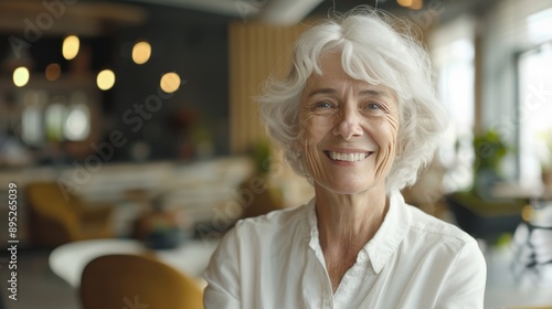 A lifelike, detailed image of a cheerful older woman with white hair and a white shirt © ping