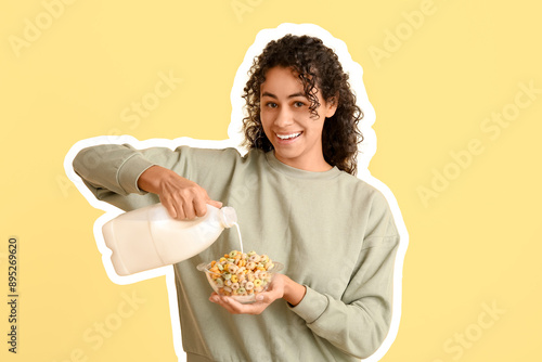 Emotional young woman pouring milk into bowl of tasty cereal rings on color background