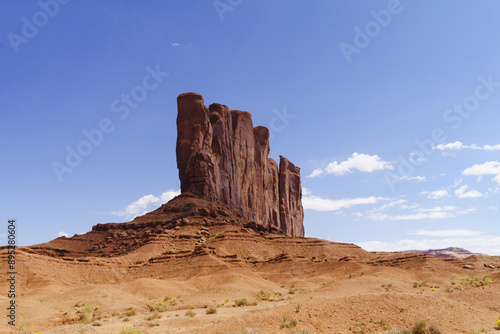 Summer view of red sandstone tower with cliff on the desert of Monument Valley, Arizona, USA 