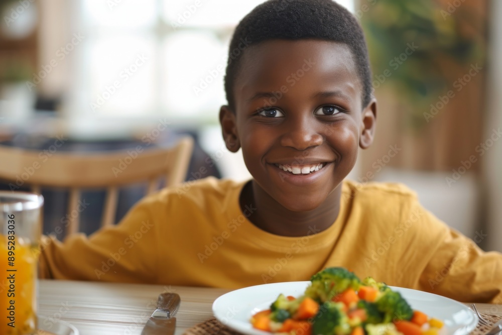 Young boy smiling while enjoying a home cooked meal Young boy smiling while enjoying a home cooked meal