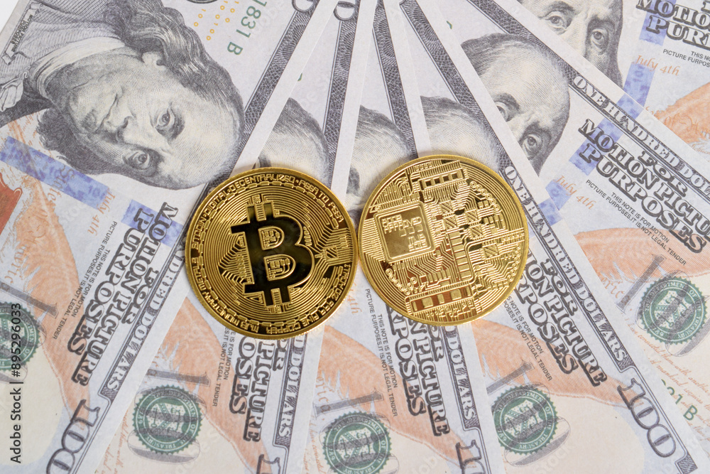 Golden symbolic coin Bitcoin on banknotes of one hundred dollars. Exchange bitcoin cash for a dollars. Cryptocurrency on US dollar bills. Savings, investments concept. Digital modern method of payment Golden symbolic coin Bitcoin on banknotes of one hundred dollars. Exchange bitcoin cash for a dollars. Cryptocurrency on US dollar bills. Savings, investments concept. Digital modern method of payment