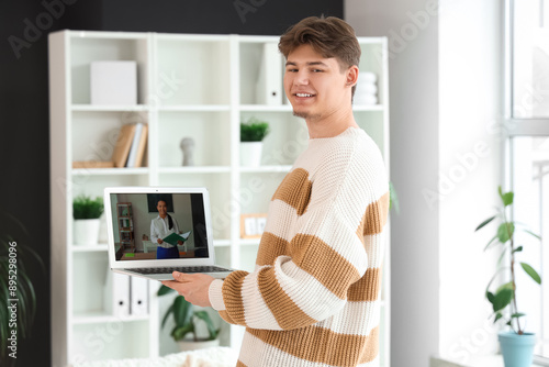 Male student studying with ...