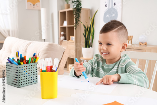 Funny little boy drawing wi...