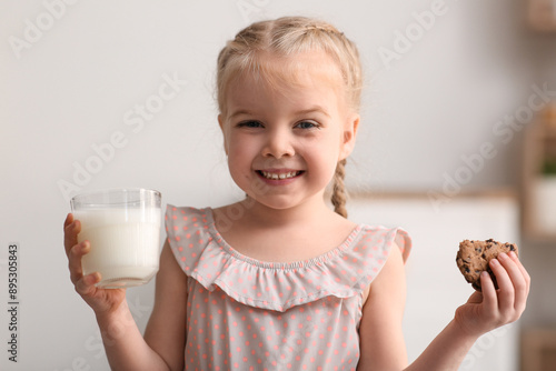 Happy little girl with cook...