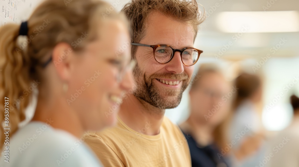 A group of colleagues are having a casual conversation in a bright room, highlighting a collaborative and friendly work environment during a meeting or break. A group of colleagues are having a casual conversation in a bright room, highlighting a collaborative and friendly work environment during a meeting or break.