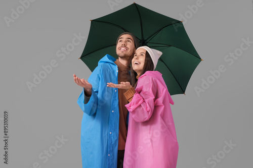 Young couple in raincoats w...