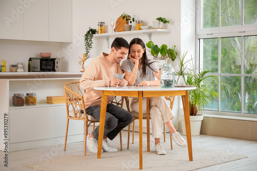 Young couple saving money f...