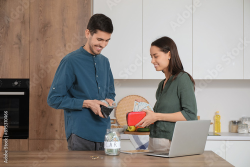 Young couple with wallets a...