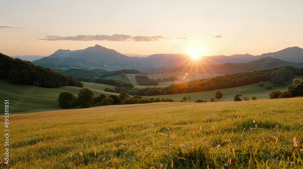 Fototapeta premium An expansive view of rolling hills and valleys bathed in the warm glow of sunrise, showcasing the serene beauty of the countryside as a new day begins.