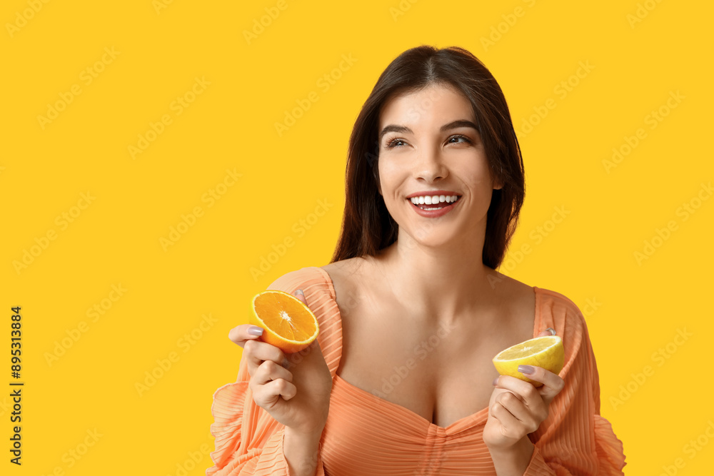 Beautiful young woman with lemon and orange on color background Beautiful young woman with lemon and orange on color background