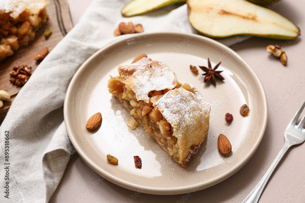 Plate with piece of tasty pear strudel and cut fresh fruit on brown background Plate with piece of tasty pear strudel and cut fresh fruit on brown background