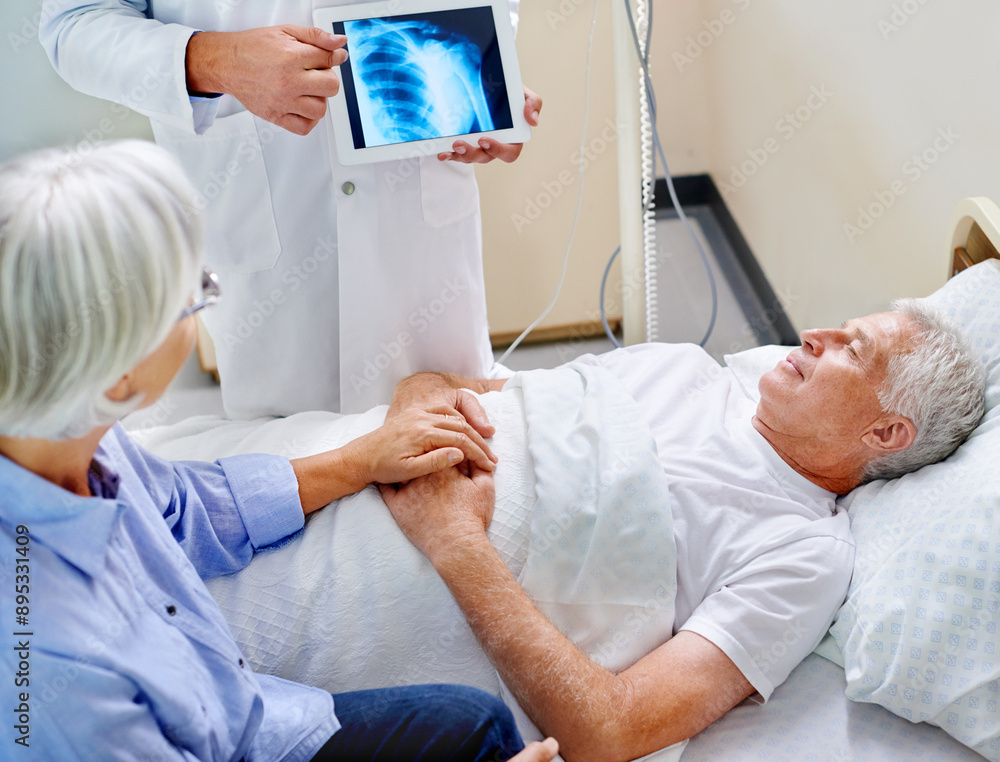 Doctor, senior and patient with xray on tablet for consultation with screen for evaluation of joint condition and arthritis. Old man, wife and support in hospital for mri on shoulder and bursitis. Doctor, senior and patient with xray on tablet for consultation with screen for evaluation of joint condition and arthritis. Old man, wife and support in hospital for mri on shoulder and bursitis.