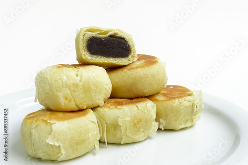 Bakpia, Bakpia Pathok kumbu hitam is a food and souvenir typical of Yogyakarta made from a mixture of red beans coated with flour. Isolated on white photo