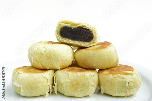 Bakpia, Bakpia Pathok kumbu hitam is a food and souvenir typical of Yogyakarta made from a mixture of red beans coated with flour. Isolated on white photo