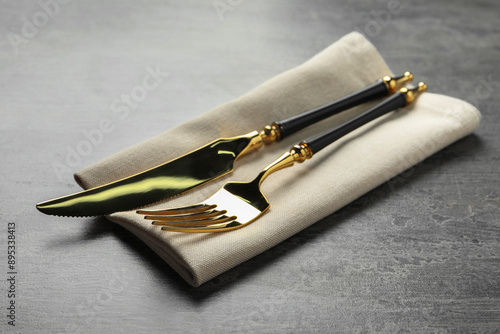 Wallpaper Mural Elegant golden cutlery and napkin on grey table Torontodigital.ca