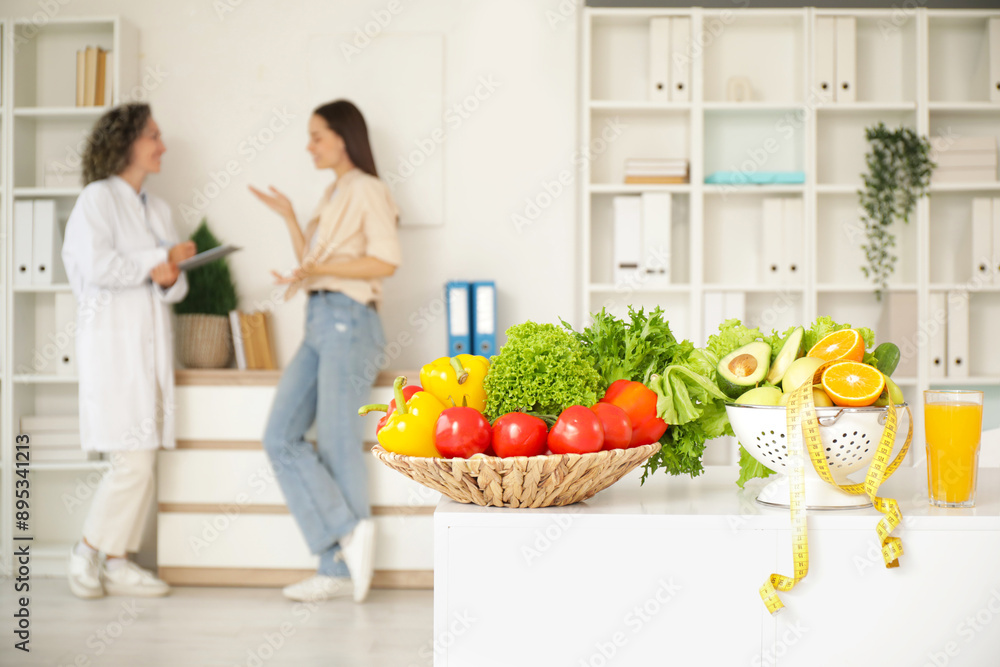 Healthy food with tape measure on table in nutritionist's office, closeup Healthy food with tape measure on table in nutritionist's office, closeup