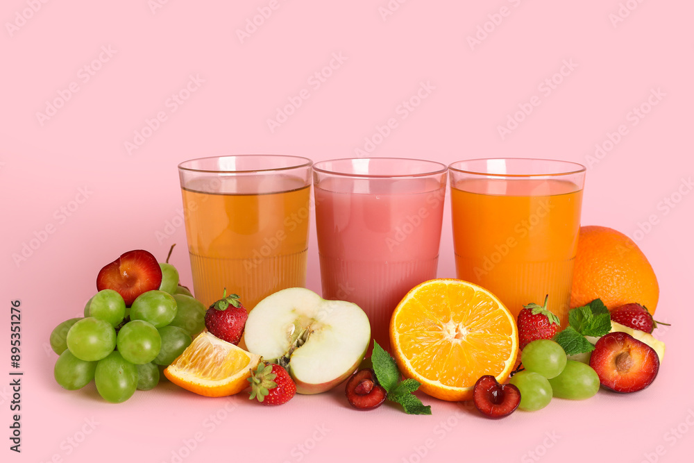 Glasses of fresh juice with different fruits and mint on pink background Glasses of fresh juice with different fruits and mint on pink background