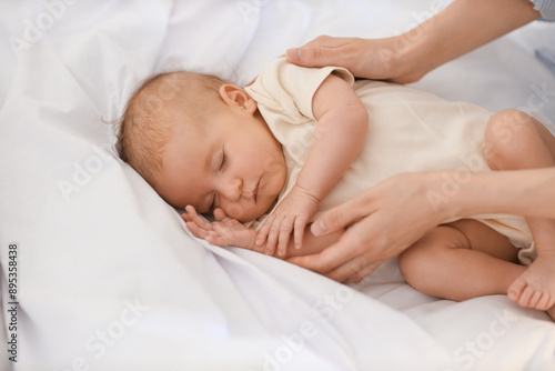 Mother with her sleeping li...