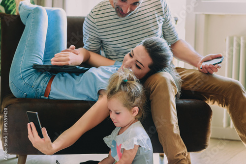 Obraz na plátně Family spending time together using technology at home