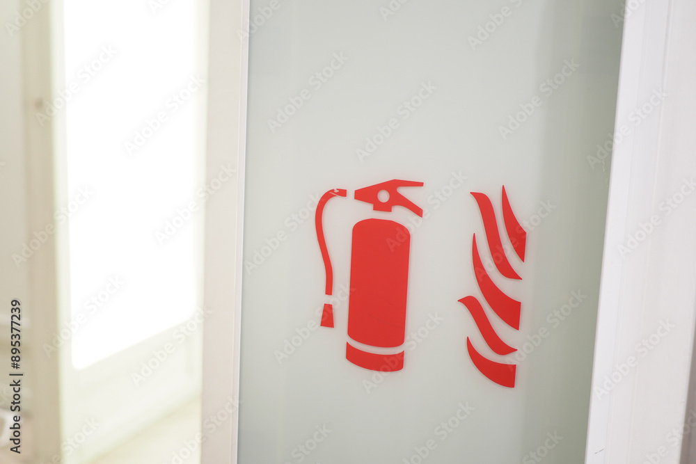 The store aisle is marked with a sign indicating the presence of a fire extinguisher and fire hose The store aisle is marked with a sign indicating the presence of a fire extinguisher and fire hose