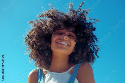 Obraz na płótnie An African American young woman with afro hair smiling outdoors w salonie