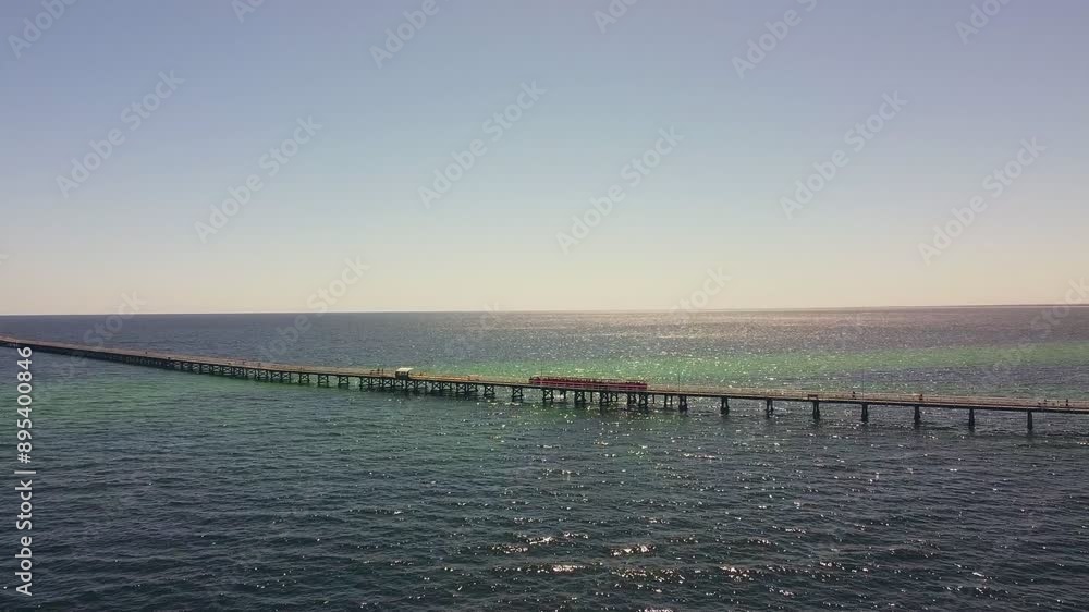 Aerial view of Busselton Jetty with train running along the jetty Aerial view of Busselton Jetty with train running along the jetty