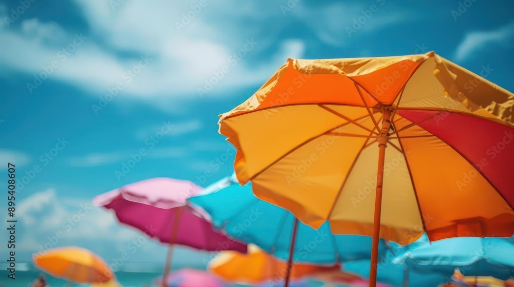 brightly colored umbrellas on a beach with people in the background brightly colored umbrellas on a beach with people in the background