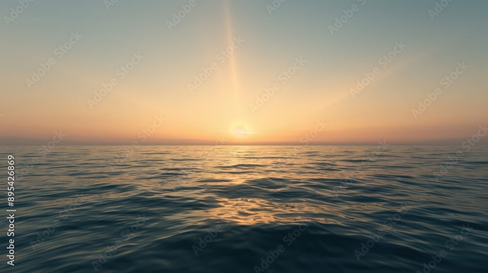 Obraz premium Sunset over calm ocean with clear sky and gentle waves.
