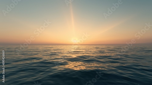 Sunset over calm ocean with clear sky and gentle waves.