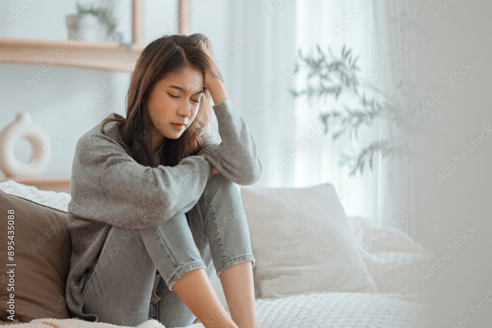 Depressed young woman sitting on couch in the living room at home, Frustrated confused female feels unhappy problem in personal life quarrel break up with boyfriend, copy space Depressed young woman sitting on couch in the living room at home, Frustrated confused female feels unhappy problem in personal life quarrel break up with boyfriend, copy space