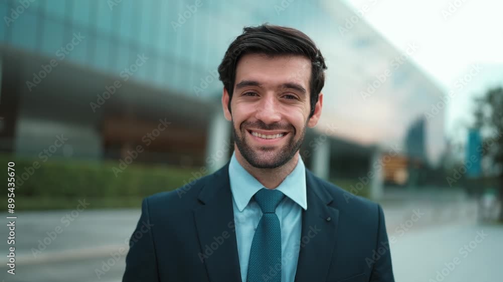 Skilled smiling business man looking at camera while standing at building. Closeup of successful man smiling at camera while wearing business suit. Happy manager look at camera. Business. Exultant. Skilled smiling business man looking at camera while standing at building. Closeup of successful man smiling at camera while wearing business suit. Happy manager look at camera. Business. Exultant.