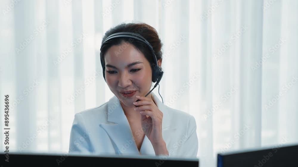 Businesswoman wearing vivancy headset working in office to support remote customer or colleague. Call center, telemarketing, customer support agent provide service on telephone video conference call Businesswoman wearing vivancy headset working in office to support remote customer or colleague. Call center, telemarketing, customer support agent provide service on telephone video conference call