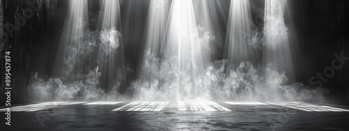 A stark background with a bright spotlight illuminating an empty stage.