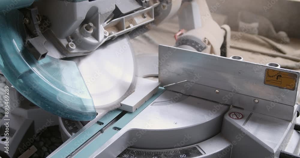 Professional carpenter uses a saw machine to cut wooden board at the workshop. Cutting wood panels. Professional carpenter uses a saw machine to cut wooden board at the workshop. Cutting wood panels.