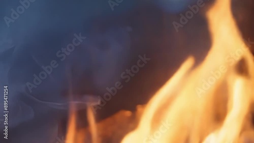 As the camera moves closer the flames can be seen visibly sputtering and struggling to stay lit before finally dying out. photo