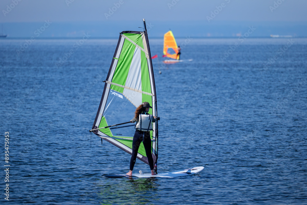 Naklejka premium Windsurfing on the bay on the Hel Peninsula in the Baltic Sea 2.06.2024