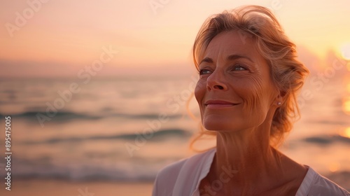 Mature Woman Breathing Ocean Air on Beach at Sunset, Smiling and Happy