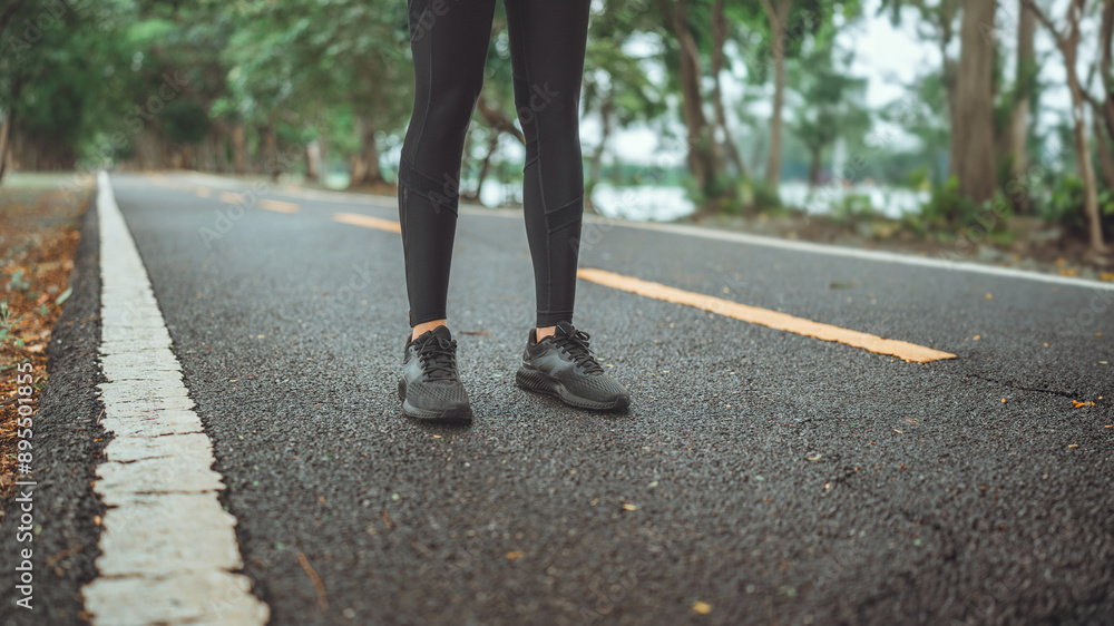 Close up - Feet of women standing on the road preparing for jogging and running in public park outdoors, Active and healthy lifestyle concept, copy space Close up - Feet of women standing on the road preparing for jogging and running in public park outdoors, Active and healthy lifestyle concept, copy space