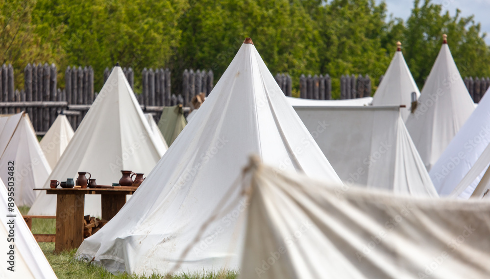White medieval tents in nature in summer White medieval tents in nature in summer