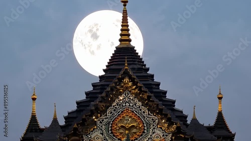 The supermoon rose above the center of the temple. photo