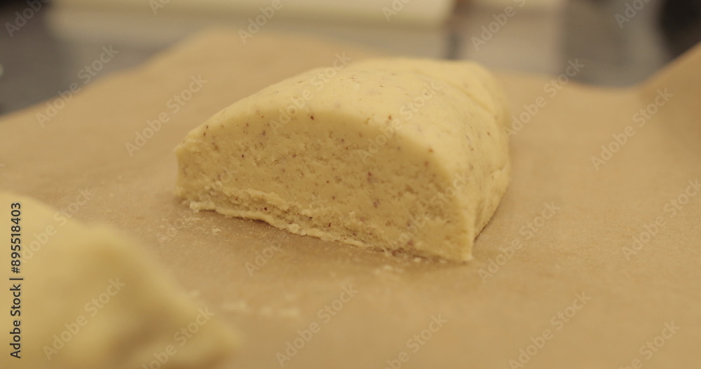 Kneading-preparation of dough for tarts. The chef kneads the dough with his hands on the kitchen table. Female hands preparing dough on a metal table Kneading-preparation of dough for tarts. The chef kneads the dough with his hands on the kitchen table. Female hands preparing dough on a metal table