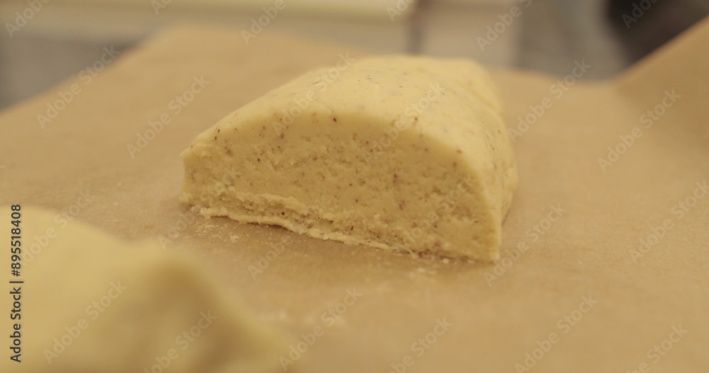 Kneading-preparation of dough for tarts. The chef kneads the dough with his hands on the kitchen table. Female hands preparing dough on a metal table Kneading-preparation of dough for tarts. The chef kneads the dough with his hands on the kitchen table. Female hands preparing dough on a metal table