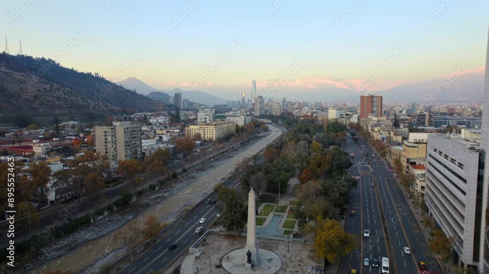 Dolly in flyover from the Obelisk to Balmaceda and the Mapocho River, Santiago de Chile and Andes Mountains at sunset. Dolly in flyover from the Obelisk to Balmaceda and the Mapocho River, Santiago de Chile and Andes Mountains at sunset.