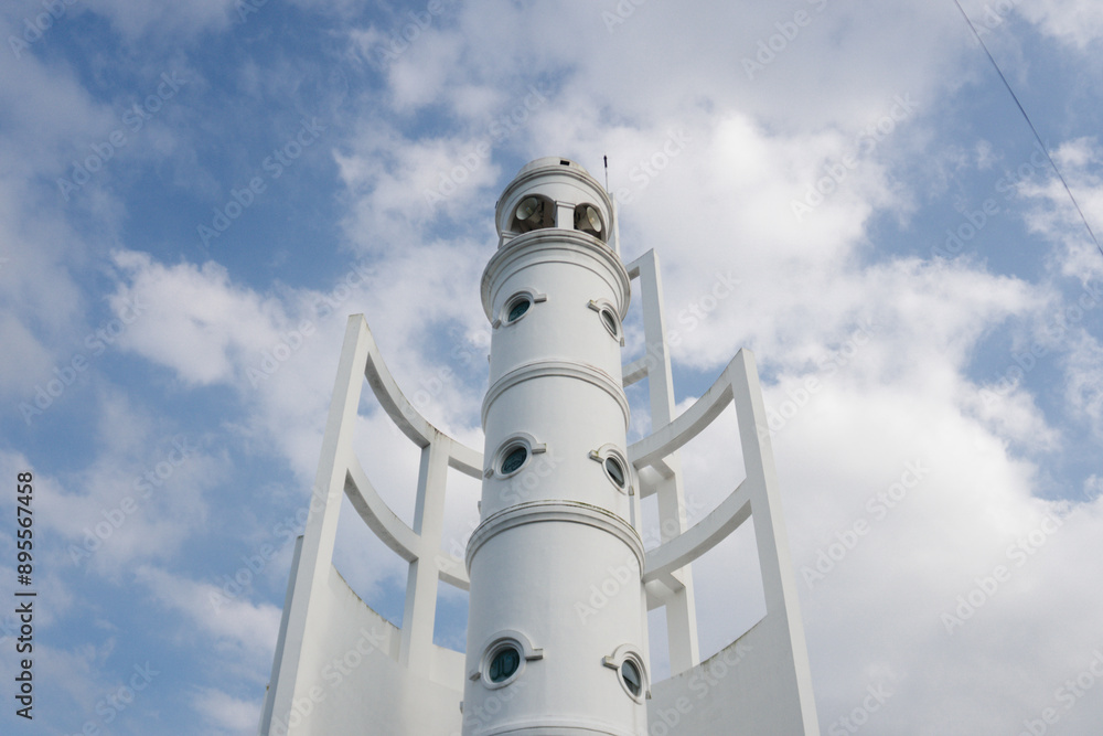 Mosque minaret building seen from a low angle Mosque minaret building seen from a low angle
