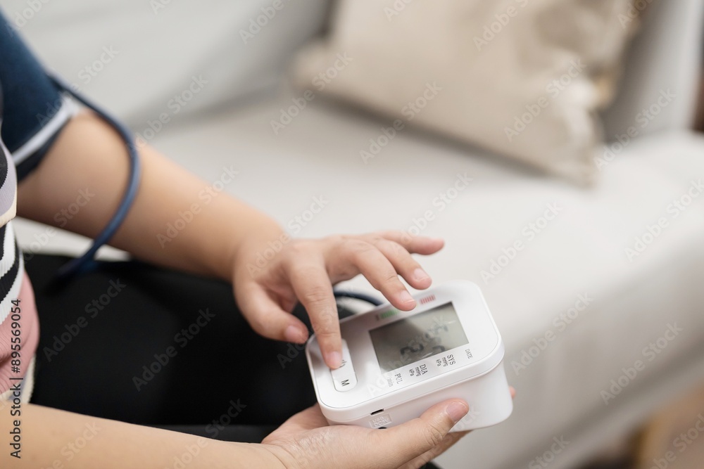 woman Overweight plus size self checks measuring blood pressure and heart rate tonometer self checkup at home woman Overweight plus size self checks measuring blood pressure and heart rate tonometer self checkup at home